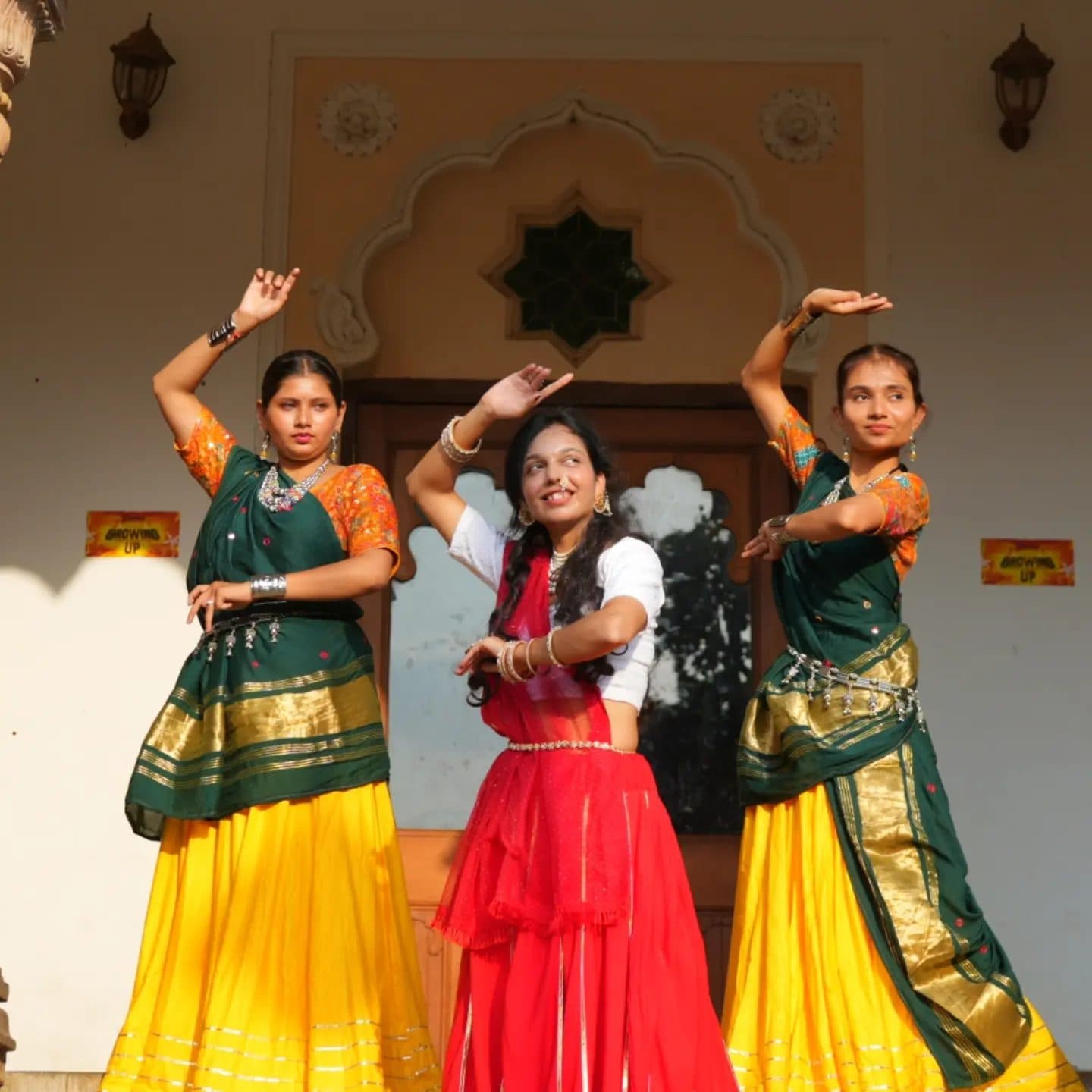 Ruchika Jharbade in a red and yellow Kutchi mirror-work chaniya choli with silver jewellery, seated on temple steps.